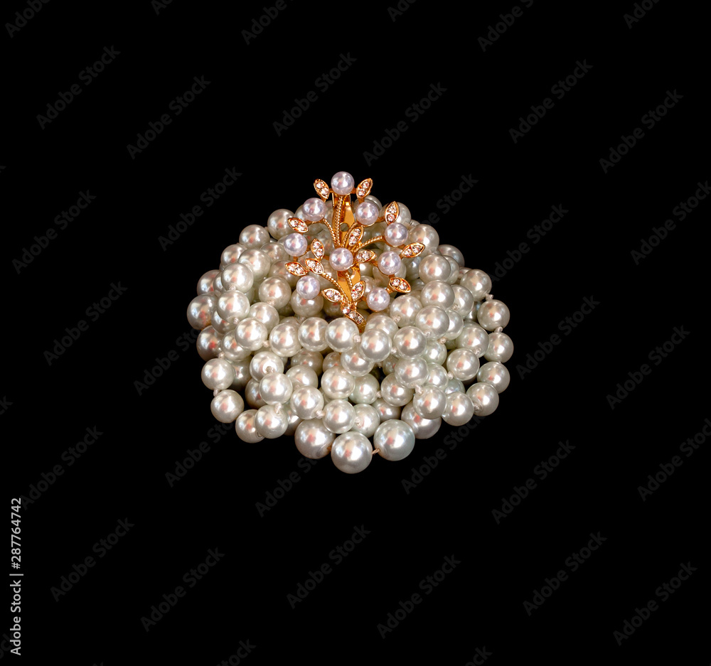 Black pearls and brooch on a white background Black pearls and brooch on a white background