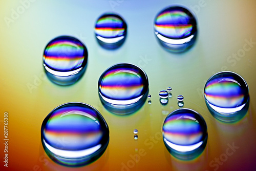 Droplest of water on a CD, reflecting, light, rainbow, prism