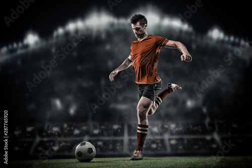 Football player with ball on field of stadium © romanolebedev