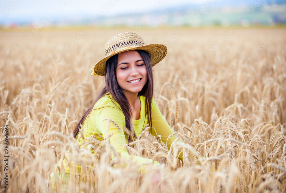 portrait of the rural girl in a straw hat