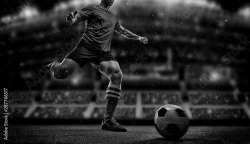 Fotografie, Obraz Football player with ball on field of stadium