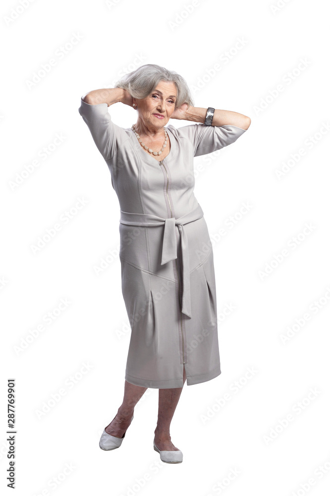 Happy senior woman wearing light dress posing on white background
