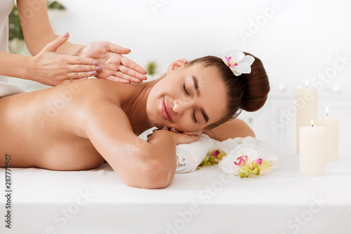 Relaxed girl enjoying massage and aroma therapy