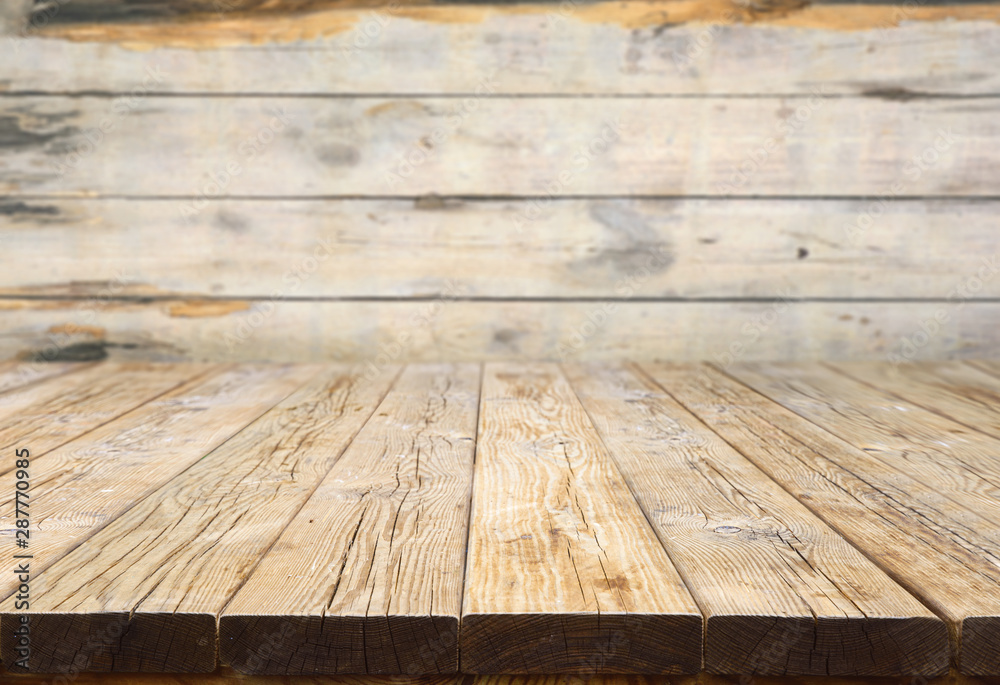 Old wood table with blurred concrete wall in room background Old wood table with blurred concrete wall in room background