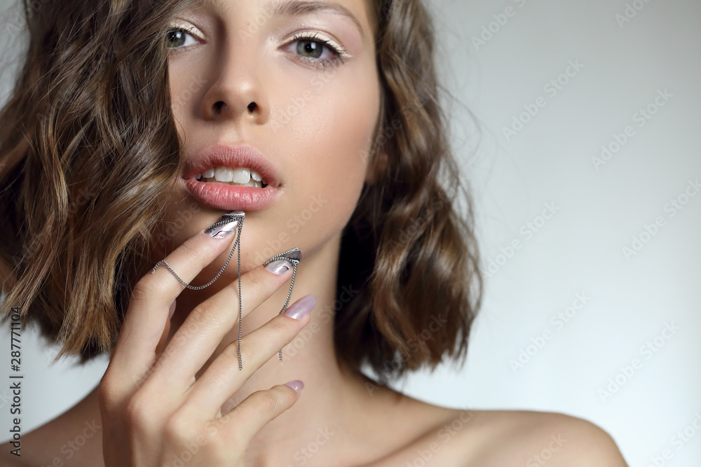 Attractive young girl with NailArt . beautiful girl with perfect skin and amazing manicure with decorations. Attractive young girl with NailArt . beautiful girl with perfect skin and amazing manicure with decorations.