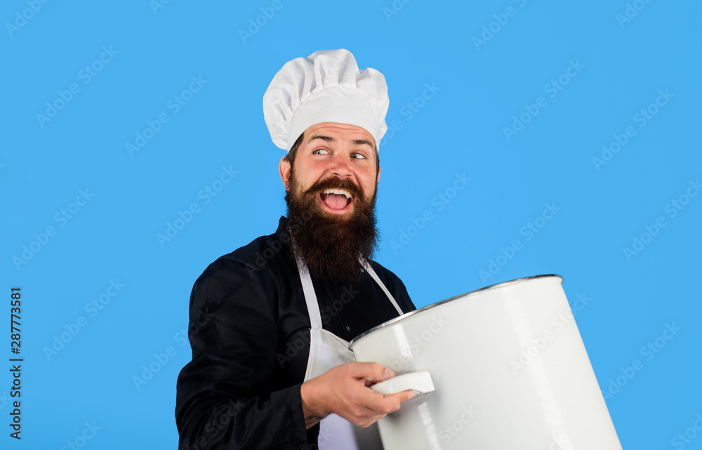Chef, cook or baker with saucepan in hand. Chef in uniform cooking with casserole. Professional chef in uniform and hat holds pan. Cooking pot. Cooking, food, profession concept - male chef holds pot. Chef, cook or baker with saucepan in hand. Chef in uniform cooking with casserole. Professional chef in uniform and hat holds pan. Cooking pot. Cooking, food, profession concept - male chef holds pot.