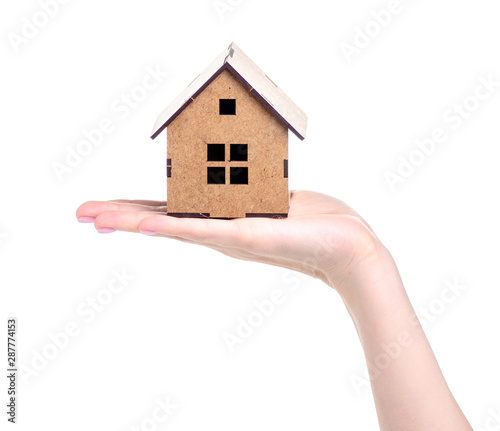 Wooden small house in hand on white background isolation