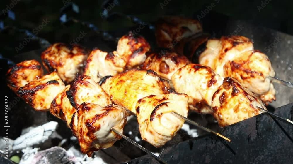 Meat pieces being fried on a charcoal grill. Grilling meat during outdoor recreation. Meat pieces being fried on a charcoal grill. Grilling meat during outdoor recreation.