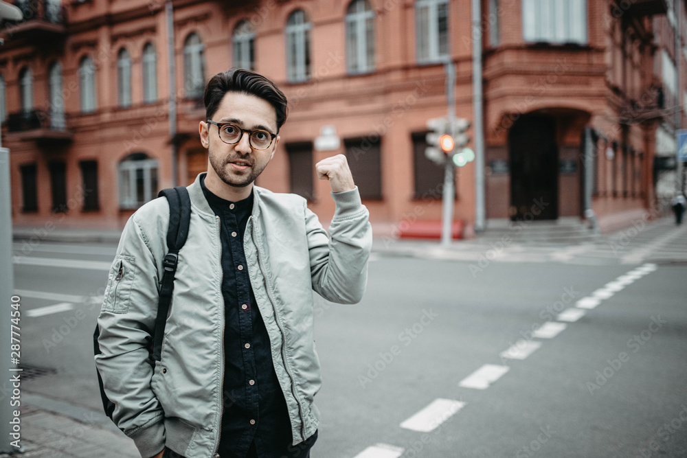 male traveler walks around the old city and studies the classical architecture of Europe male traveler walks around the old city and studies the classical architecture of Europe