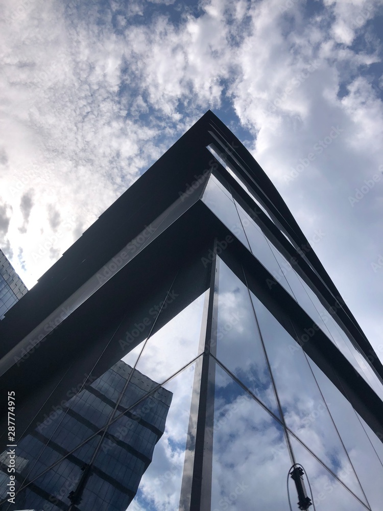 modern building with blue sky and clouds modern building with blue sky and clouds
