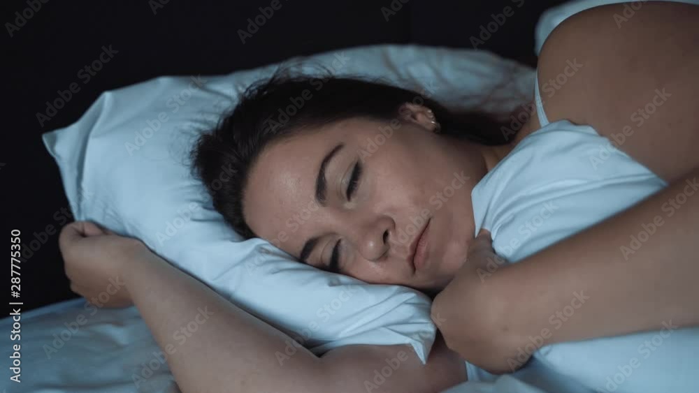 Young woman lying in bed instead of sleep at night. Insomnia concept Young woman lying in bed instead of sleep at night. Insomnia concept