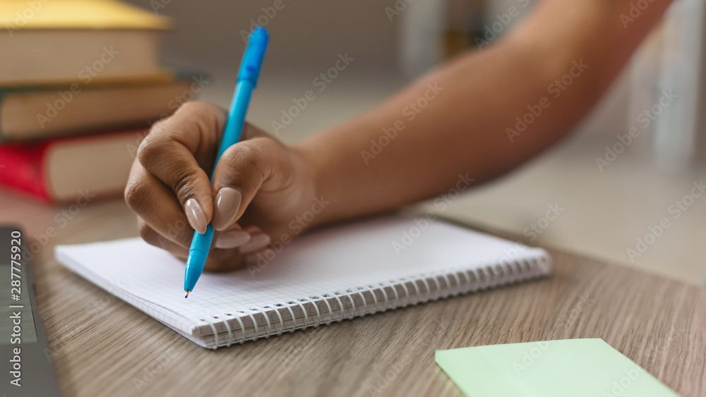 Teen black girl writing notes in notebook Teen black girl writing notes in notebook