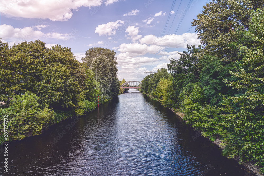 beautiful Berlin canal with bridge and cloudscape