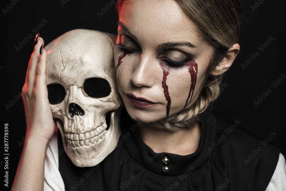 Woman holding skull on shoulder Woman holding skull on shoulder
