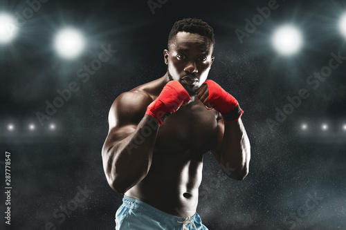Confident black fighter standing in pose and ready to fight © Prostock-studio