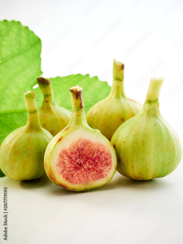 Figs fruit with leaves on white background Figs fruit with leaves on white background