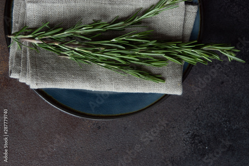 Table setting with ceraic plates and rosemary