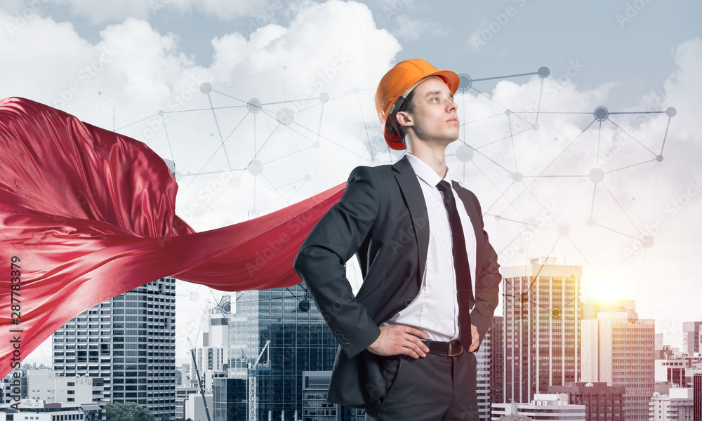 Fototapeta premium Concept of power and sucess with architect superhero in big city
