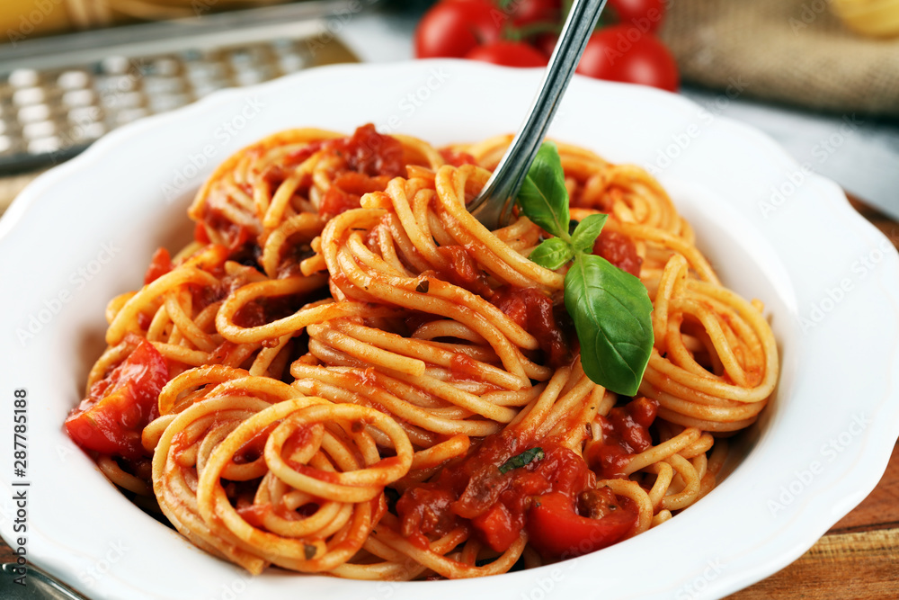 Plate of delicious spaghetti Bolognaise or Bolognese with savory minced beef and tomato sauce garnished with parmesan Plate of delicious spaghetti Bolognaise or Bolognese with savory minced beef and tomato sauce garnished with parmesan