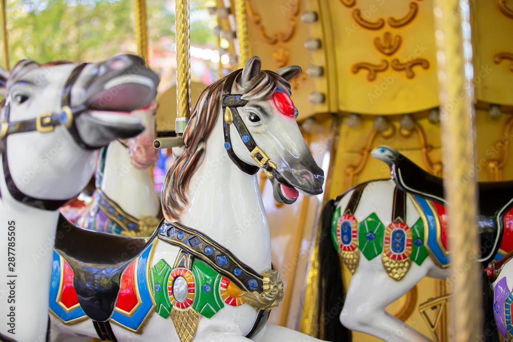 Fragment of a French carousel with horses. Children's attraction.