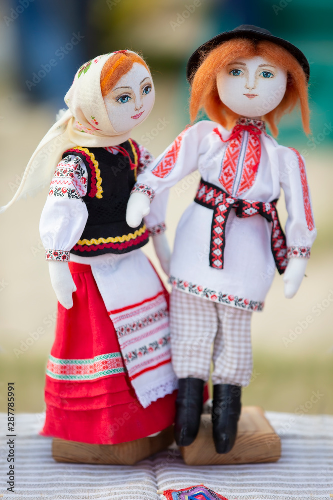 Vertically Slavic doll man and woman in national clothes. Symbol of Ukrainian and Belarusian culture
