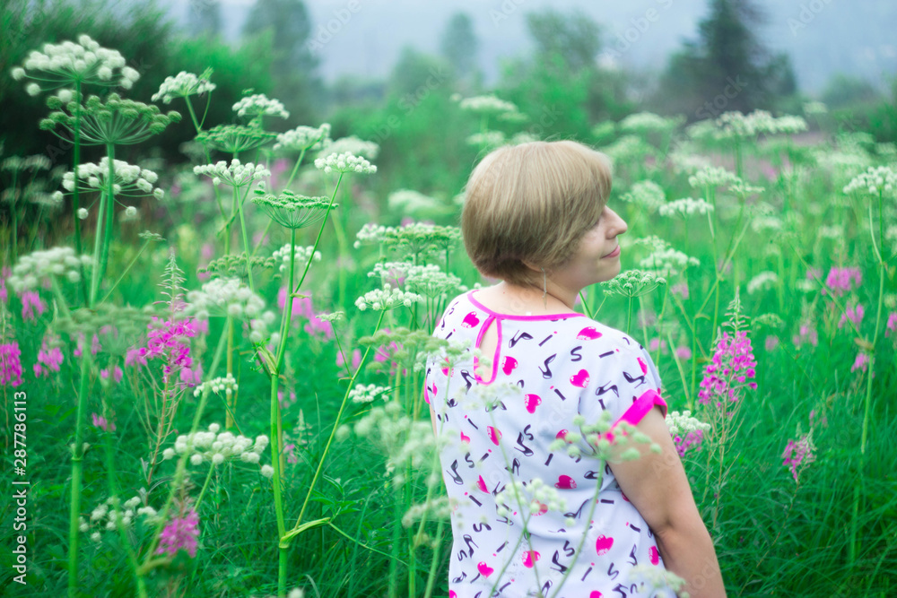 girl in a light jacket on a flower meadow girl in a light jacket on a flower meadow