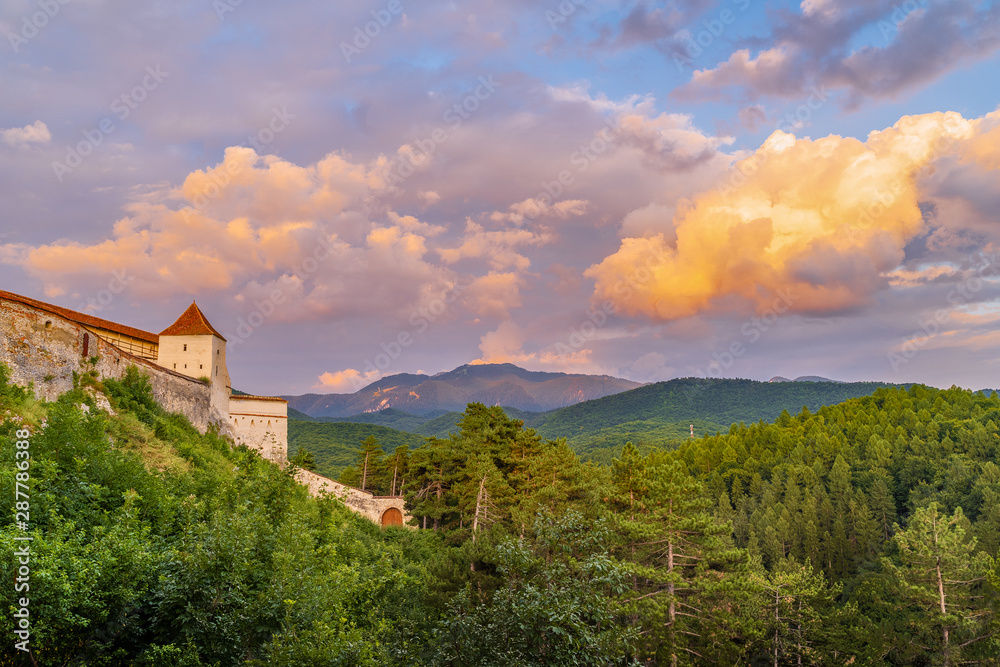 Landscape with Medieval fortress Rasnov at sunset, Brasov region, Transylvania, Romania