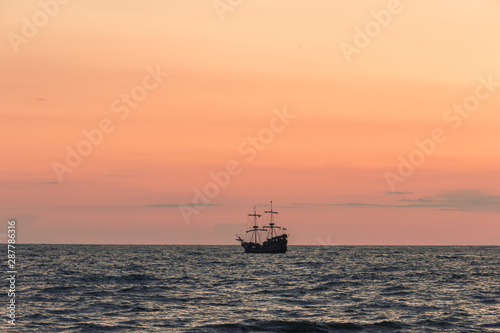 One sip sailing on the horizon of the sea at the sunset. © irena iris szewczyk
