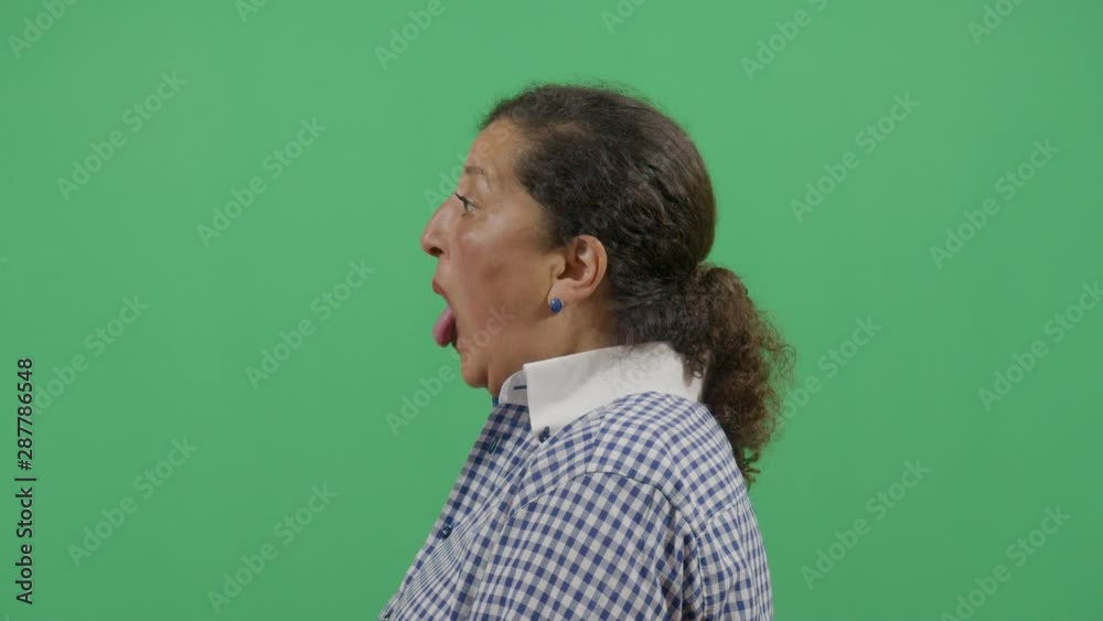 Lateral Or Side View Of A Woman Sticking Out The Tongue Like Showing It To Someone Invisible
