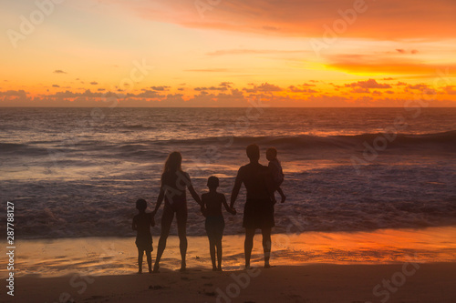 family on th beach at sunset
