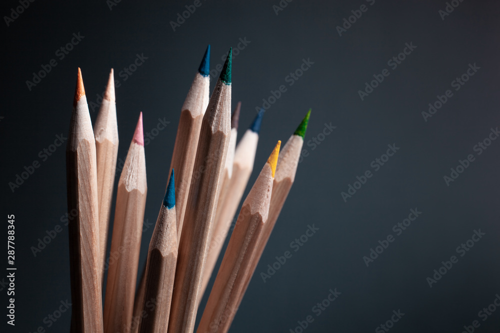 Sharpened pencils of different colors made of light wood isolated on black background. Sharpened pencils of different colors made of light wood isolated on black background.