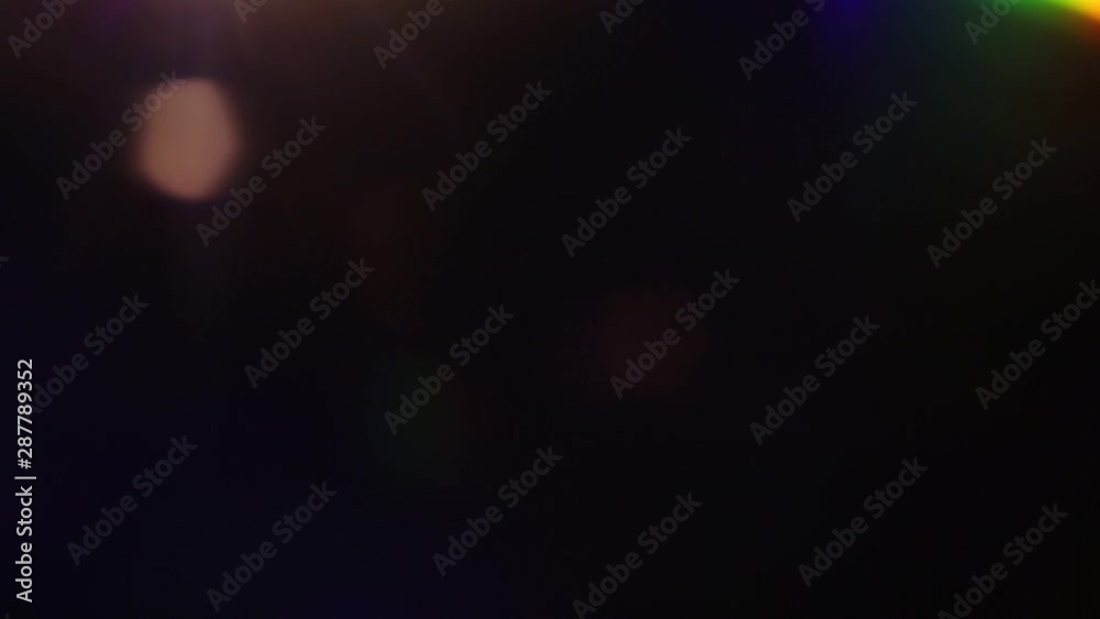 abstract multicolored light leaks on a black background. abstract multicolored light leaks on a black background.