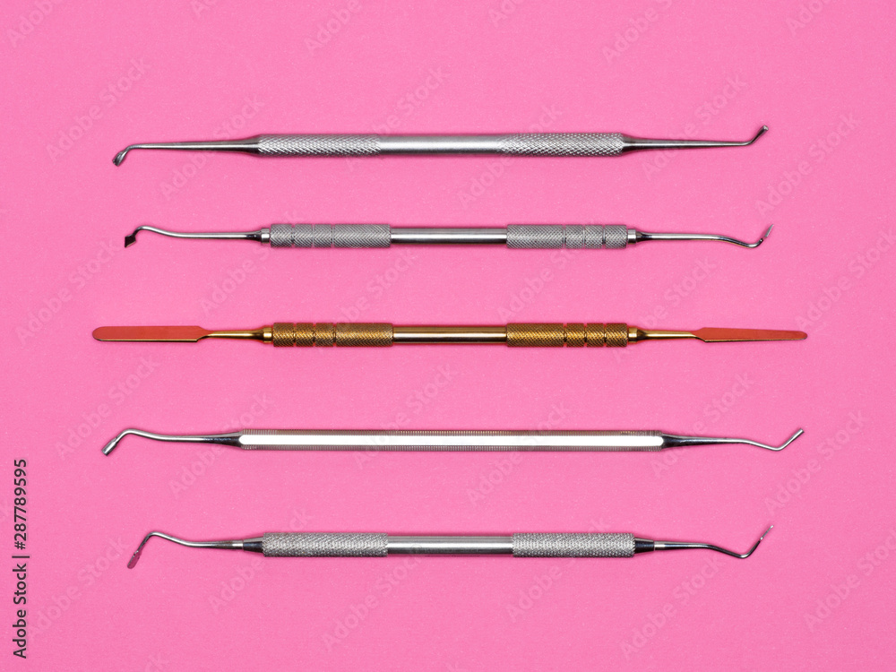 Dental instrument on pink background. Dental care concept Dental instrument on pink background. Dental care concept
