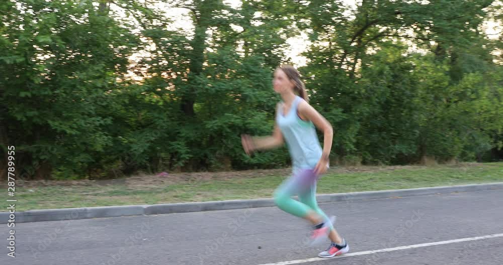 Beautiful sporty young woman running in park Beautiful sporty young woman running in park
