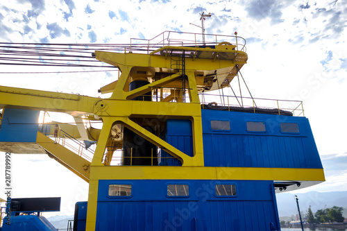 Fragment of a ship crane for loading unloading containers.