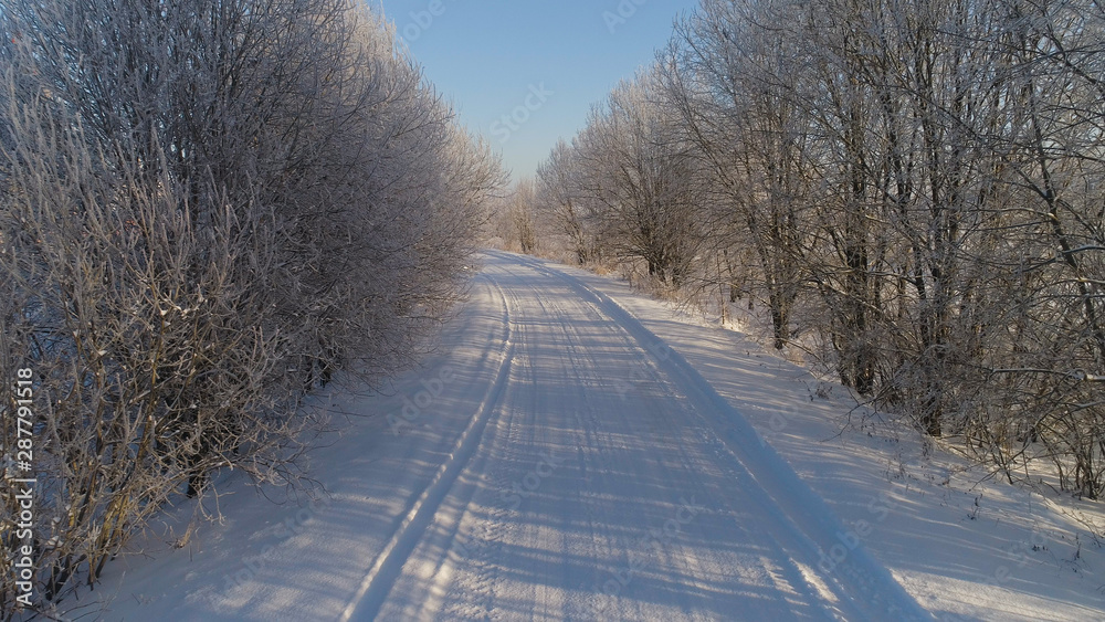 aerial view winter landscape with road and trees covered snow. winter in countryside