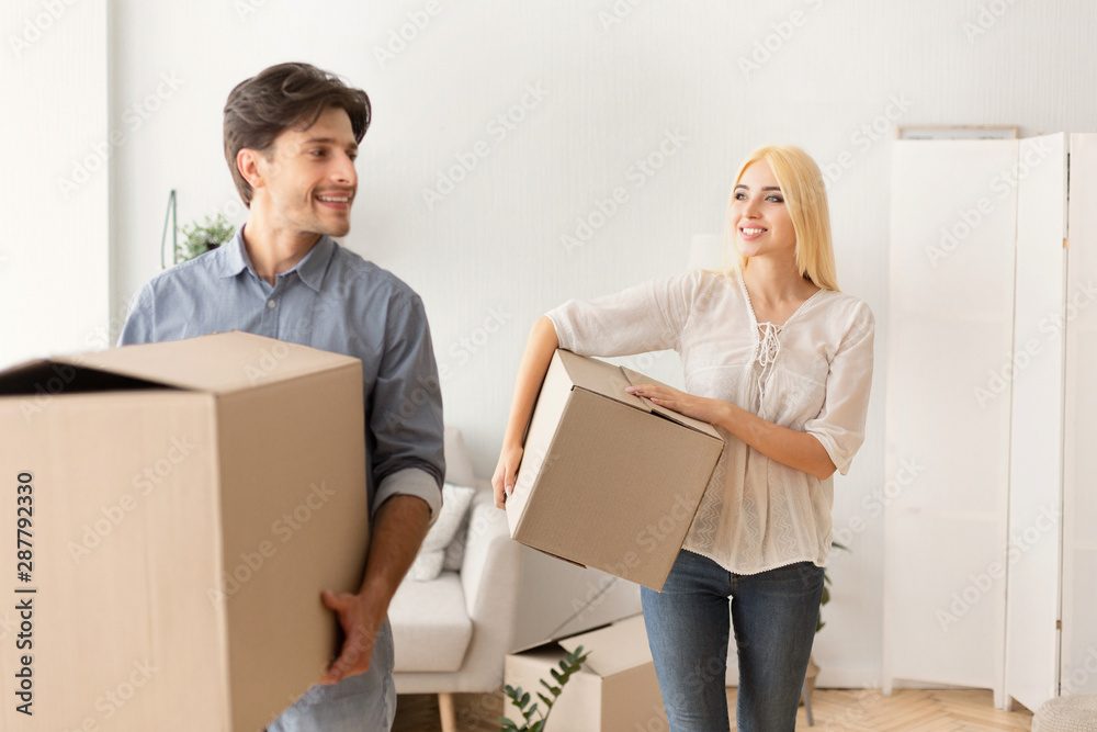 Happy Man And Woman Carrying Moving Boxes Entering New Flat Happy Man And Woman Carrying Moving Boxes Entering New Flat