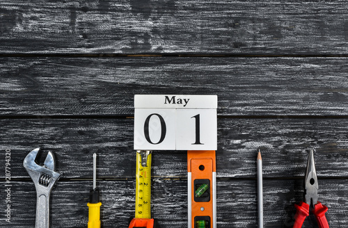 Top view of variety handy tools on black wooden background with copy space for your text for Worker's day, Labor's day, labour's day background.