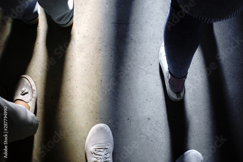 shadow of the feet of people look down
