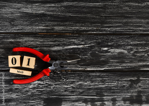 Top view of handy tools on black wooden background with copy space for your text for Worker's day, Labor's day, labour's day background.