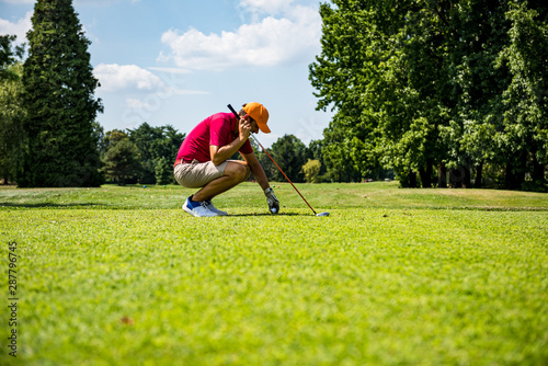 Close up Golfer is driving golf ball to green course