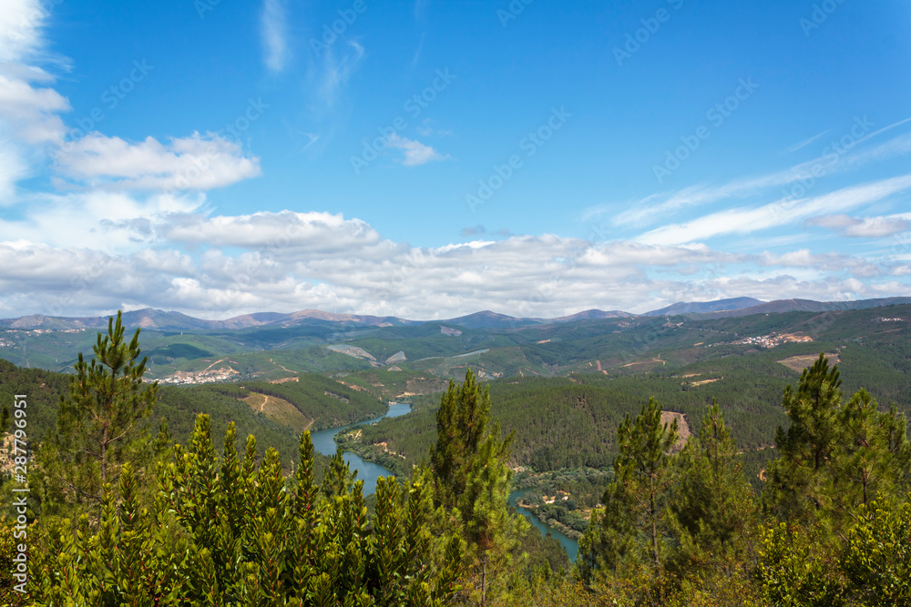 River zigzag andblandscape with mountains and pine forest surrounding