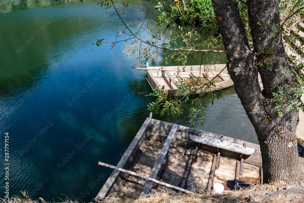 Wooden boats moored by the river Wooden boats moored by the river
