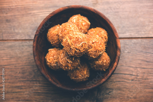 Jaggery coconut Laddoo / Nariyal gur ke laddu, indian sweet food for festivals like rakshabandhan/rakhi pournima photo