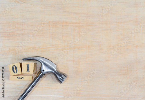 Top view of handy tools with May 1 text wooden block calendar on light wooden board background with copy space for your text for Worker day, Labor day, labour day.