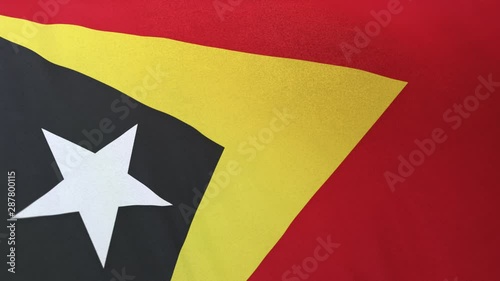 East Timor national flag seamlessly waving on realistic satin texture 29.97FPS photo