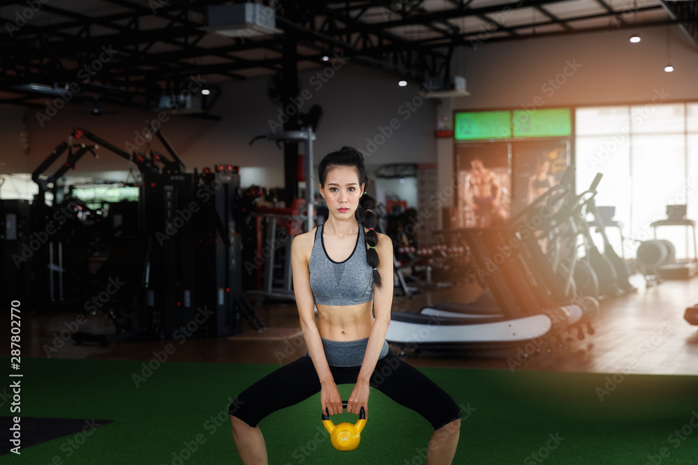 Person with kettlebell doing a sumo squat Stock Photo