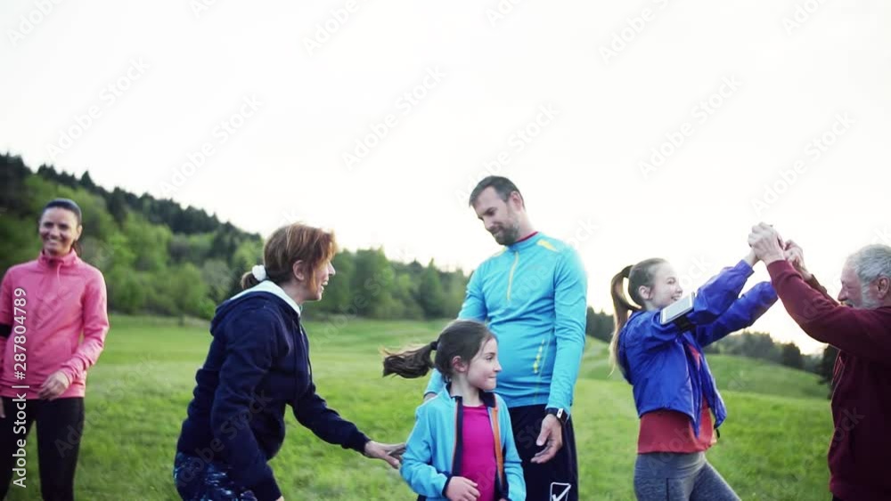 Large group of fit and active people resting after doing exercise in nature. Large group of fit and active people resting after doing exercise in nature.