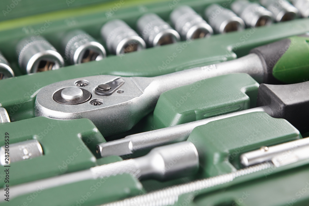 ratchet set with heads, different socket wrenches close-up in a green plastic case ratchet set with heads, different socket wrenches close-up in a green plastic case