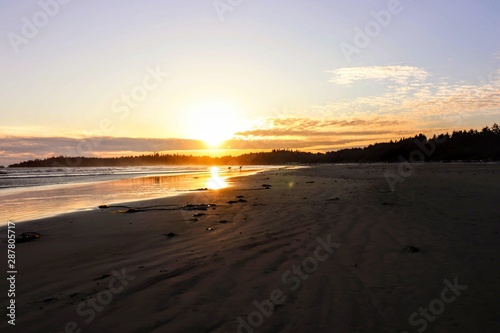 Silhouettes surfers walking on the sandy beach during sunset handmade board